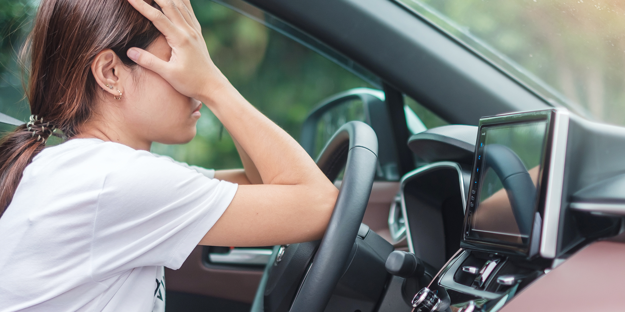 Frustrated driver with elbows on steering wheel